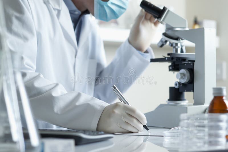 Scientist conducting research with microscope stock photo Scientist conducting research with microscope stock photo