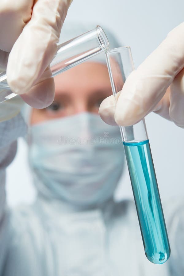 The scientist conducts experiments with two test tubes royalty free stock image