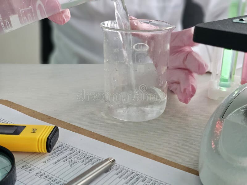 Scientist conducts water testing in laboratory with various equipment stock photography