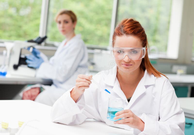 Scientist dropping liquid in a beaker