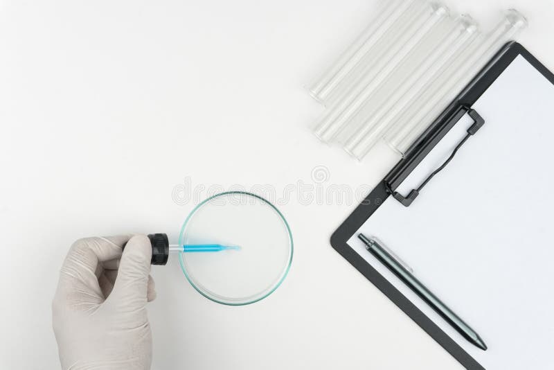 laboratory scene, the scientist holding the glass stirring rod