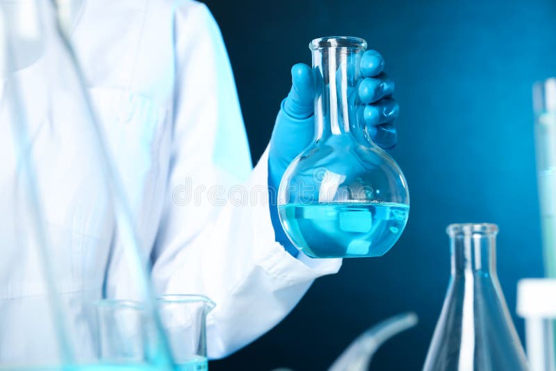 Scientist Holding Florence Flask with Liquid on Color Background