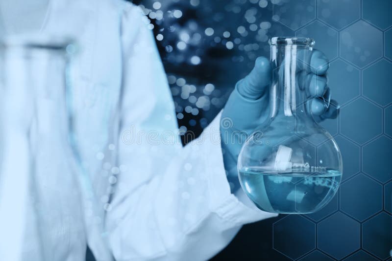 Scientist holding glass flask with liquid on color background. Solution chemistry royalty free stock photography
