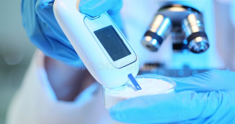 Scientist laboratory technician uses a tester to analyze white medical powder stock video