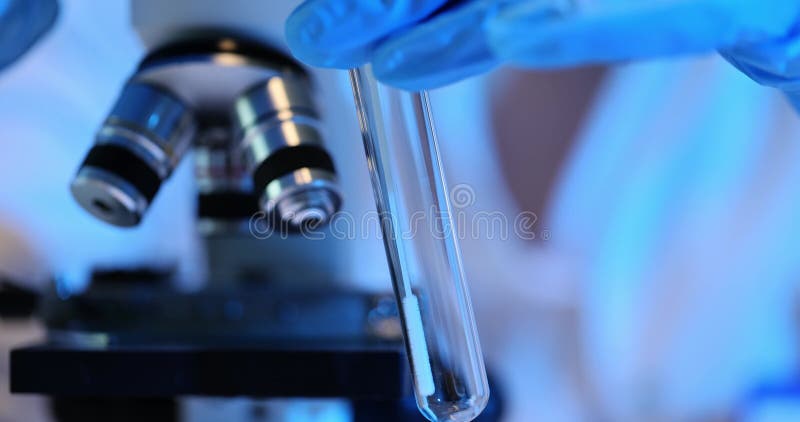 Scientist makes smear inside test tube with applicator