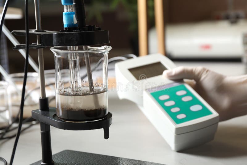 Scientist Measuring Acidity and PH of Soil at Table. Laboratory