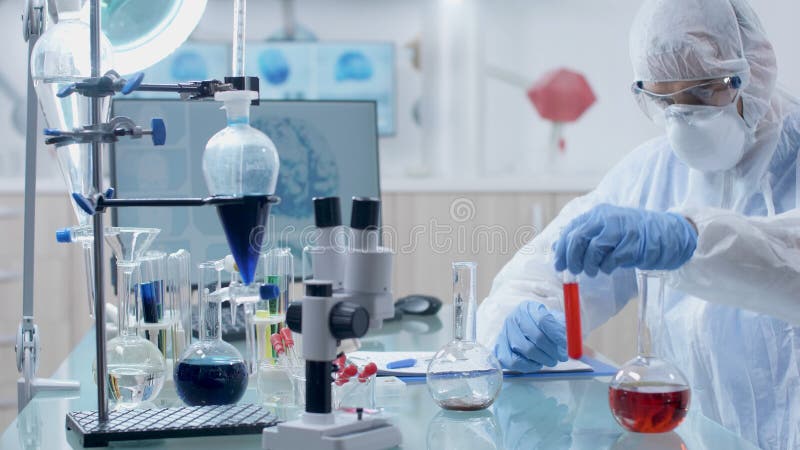 Scientist microbiologist doctor working with transparent glassware stock photo
