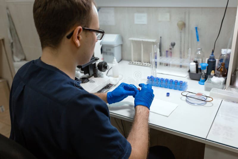 Scientist Prepare Blood Sample for Research on Microscope. Placing