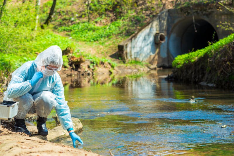 Scientist in protective suite taking water samples royalty free stock photos Scientist in protective suite taking water samples royalty free stock photos