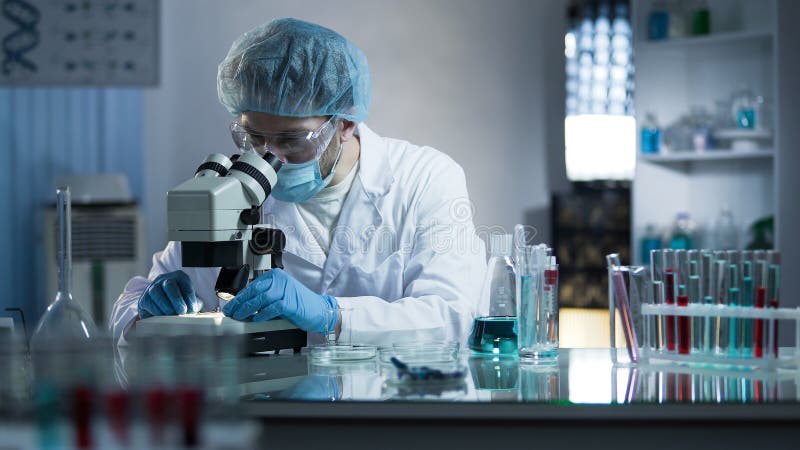 Scientist studying dna branches for additional information in cloning process royalty free stock photo Scientist studying dna branches for additional information in cloning process royalty free stock photo