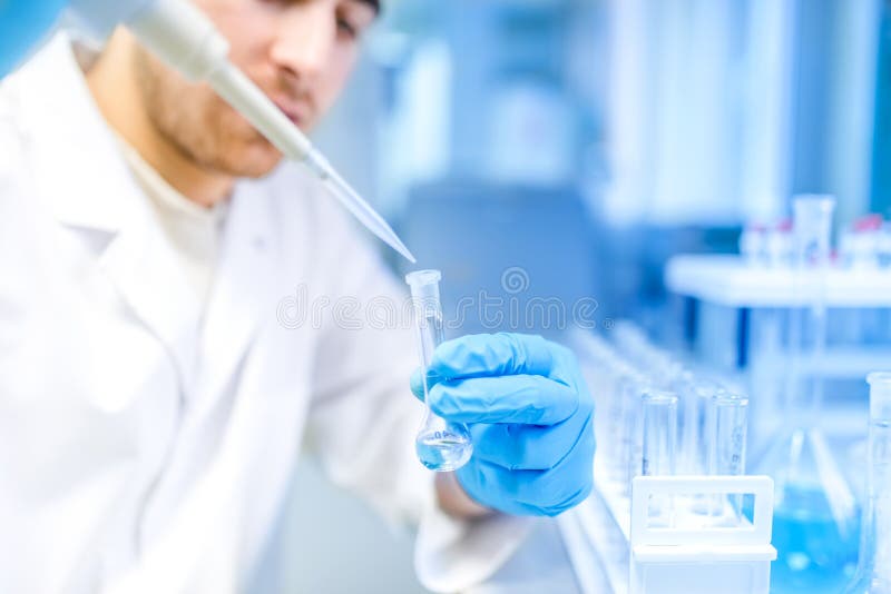 Scientist using medical tool for extraction of liquid from samples in special laboratory or medical room