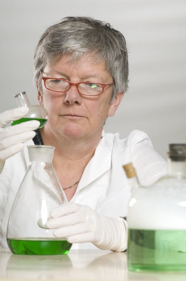 Scientist is working with a green liquid