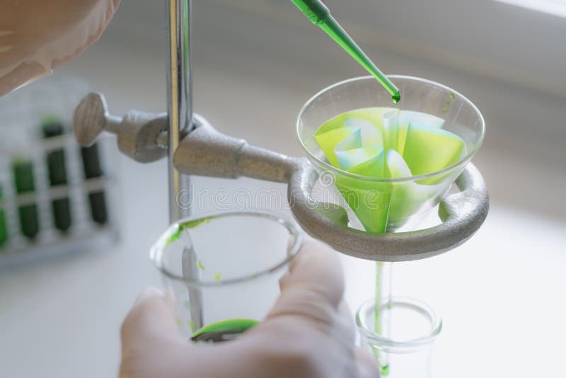Scientists are chemical filtration by filtering through filter paper in the chemistry laboratory. stock photography Scientists are chemical filtration by filtering through filter paper in the chemistry laboratory. stock photography