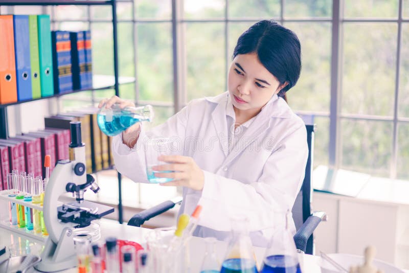 Scientists are experimenting with colorful chemicals in beakers royalty free stock photos
