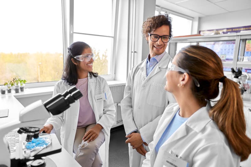 Scientists with microscopes working in laboratory royalty free stock photography