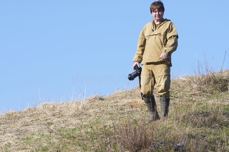 Scientists photographer standing on top of a hill