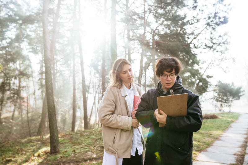 Scientists are studying plant species and inspect trees in the forest. royalty free stock photos