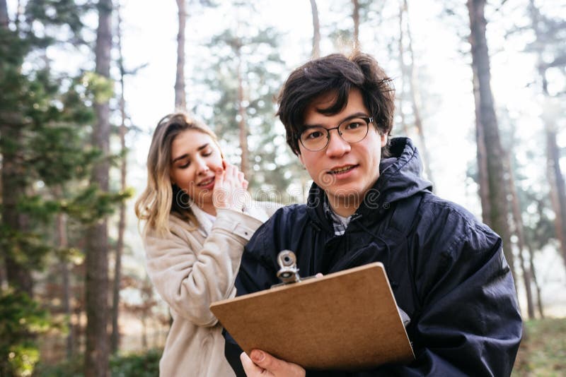 Scientists are studying plant species and inspect trees in the forest. royalty free stock photo