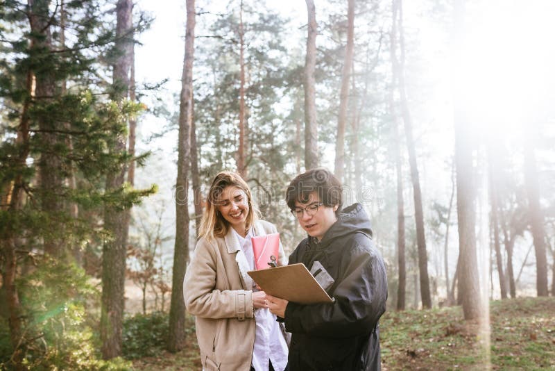 Scientists are studying plant species and inspect trees in the forest. royalty free stock images