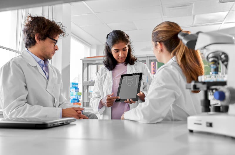 Scientists with tablet pc working in laboratory stock images