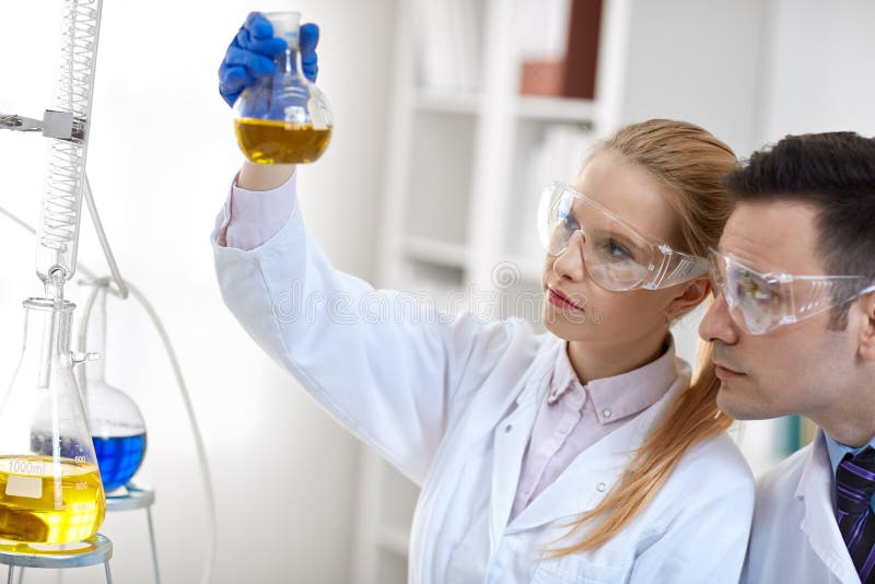 Scientists working with chemicals and equipment royalty free stock image