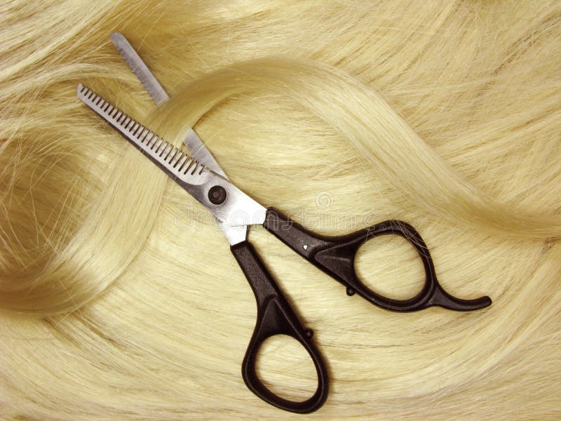 Scissors in blond hair