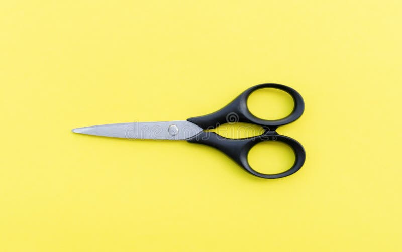 Scissors isolated on yellow background, after some edits.