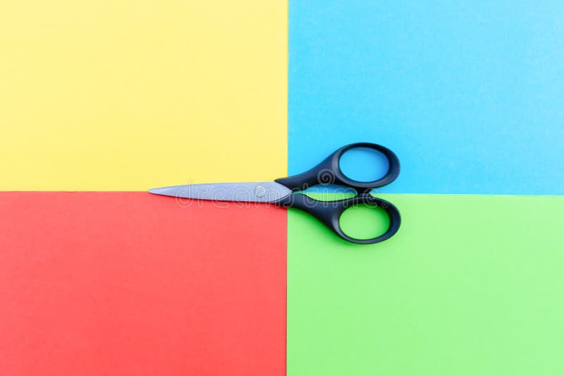 Scissors placed on colored papers royalty free stock photography