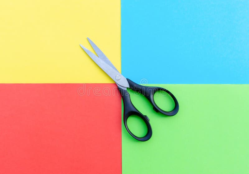 Scissors placed on colored papers stock photos