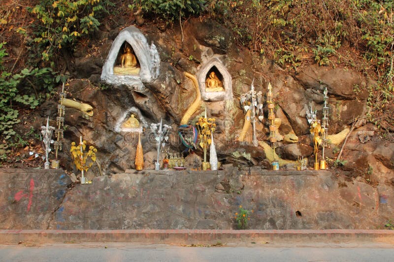 cliff and statues of buddhist divinities in luang prabang in laos. cliff and statues of buddhist divinities in luang prabang in laos