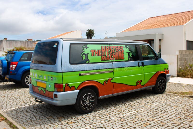 Quiaios / Portugal - July 03, 2021: A volkswagen van parked on a residential area and decorated as The Mystery Machine, a replica of the vehicle of Scooby-Doo. Quiaios / Portugal - July 03, 2021: A volkswagen van parked on a residential area and decorated as The Mystery Machine, a replica of the vehicle of Scooby-Doo