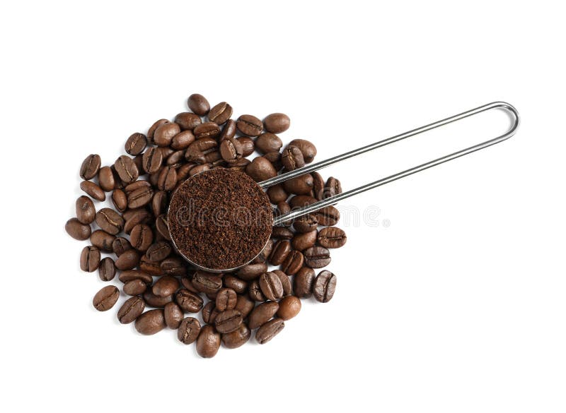 Scoop with coffee grounds and roasted beans on white background