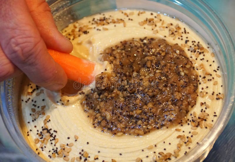 Scooping Hummus with a Baby Carrot Stock Photo Image of hummus