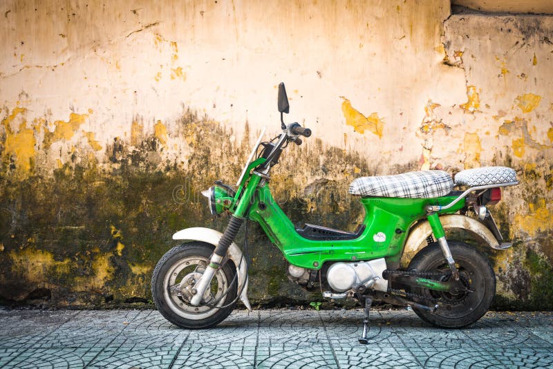 Scooter parked at old building in Vietnam, Asia.