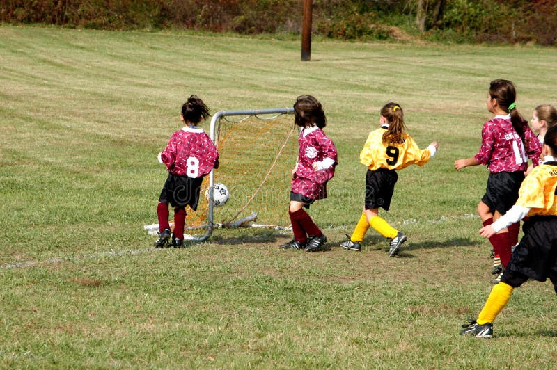 Soccer Football Kick. Young Player Kicking Soccer Ball Stock Photo