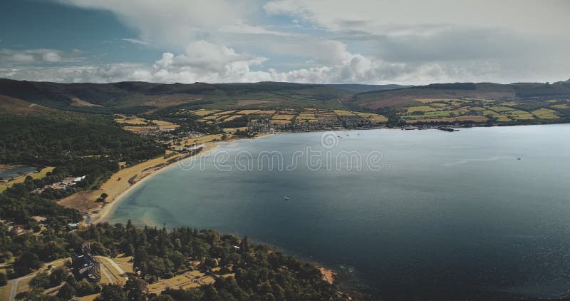 Scotland`s ocean, Brodick Harbour aerial view: ferry, ships, boats. Majestic seascape of pier