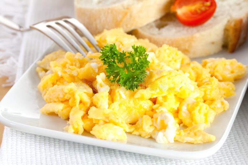 Scrambled eggs with bread stock images