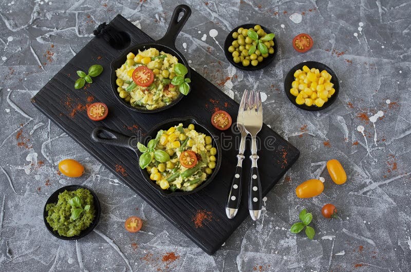 Scrambled Eggs with Green Beans, Corn, Green Peas and Fresh Basil Stock