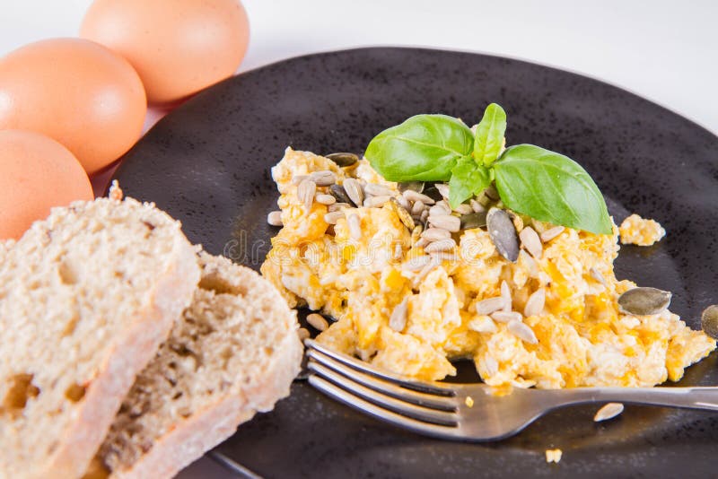 Scrambled eggs with seeds stock photo. Image of breakfast - 138056626