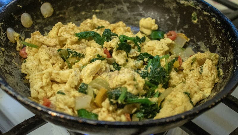 Scrambled eggs on pan stock photo. Image of eggs, fried - 135517828