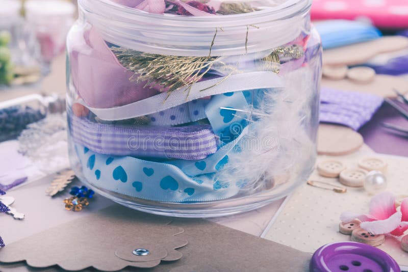 Scrapbooking craft materials in a glass bottle. Cardboard color shapes stock images, royalty-free photos and pictures