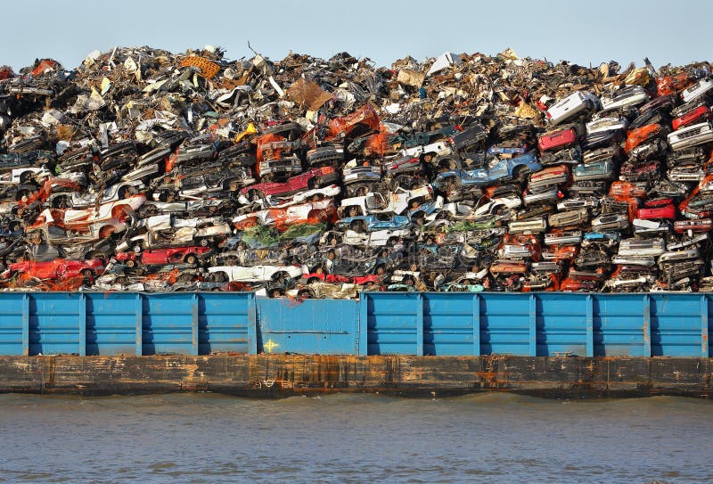 Scrap metal barge loaded with crushed cars for recycling. Scrap metal barge loaded with crushed cars for recycling.