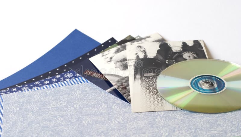 Scrapbooking supplies: Paper, photo CD, photos.