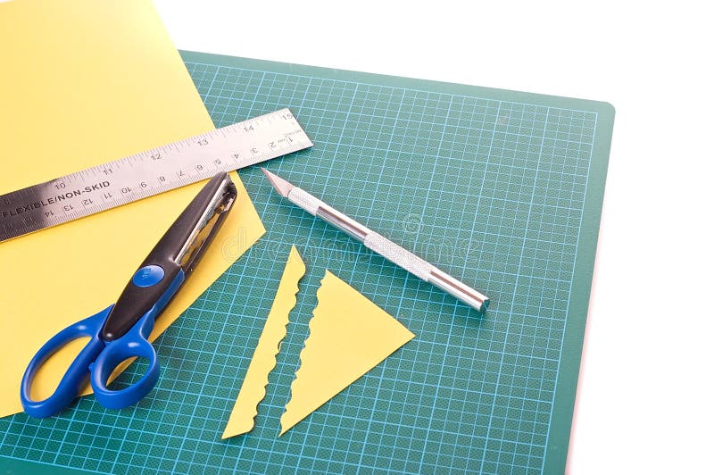 Scrapbooking material: ruler, scissors, mat and knife
