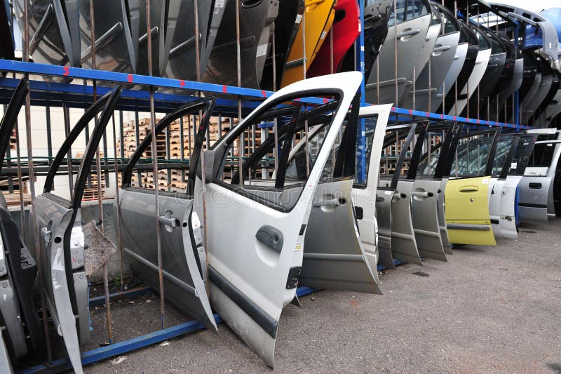 ASHDOD, ISR - JAN 04:Old cars doors being scrapped during Scrappage program on Jan 04 2010.It's an government budget program to remove inefficient, high emissions vehicles from the road for safety.