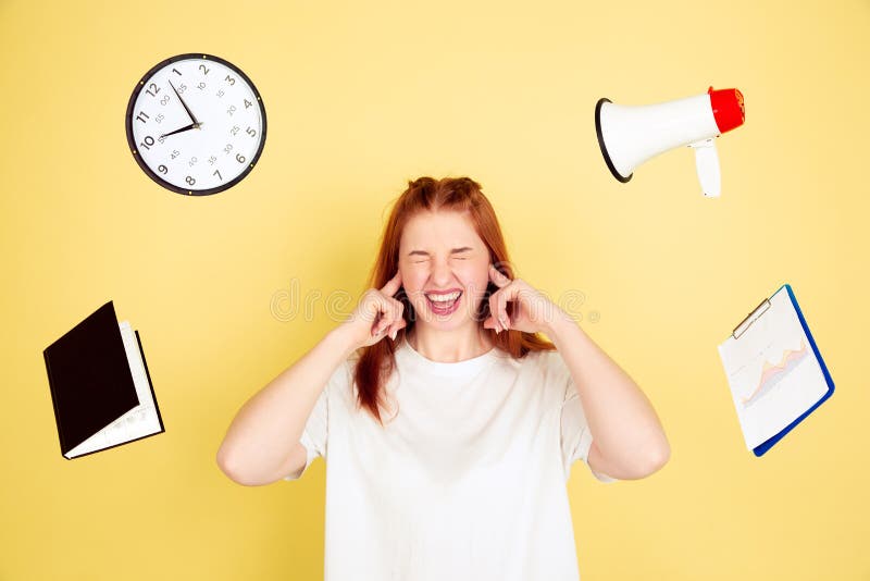 Caucasian young woman`s portrait on yellow background, too much tasks royalty free stock photography Caucasian young woman`s portrait on yellow background, too much tasks royalty free stock photography