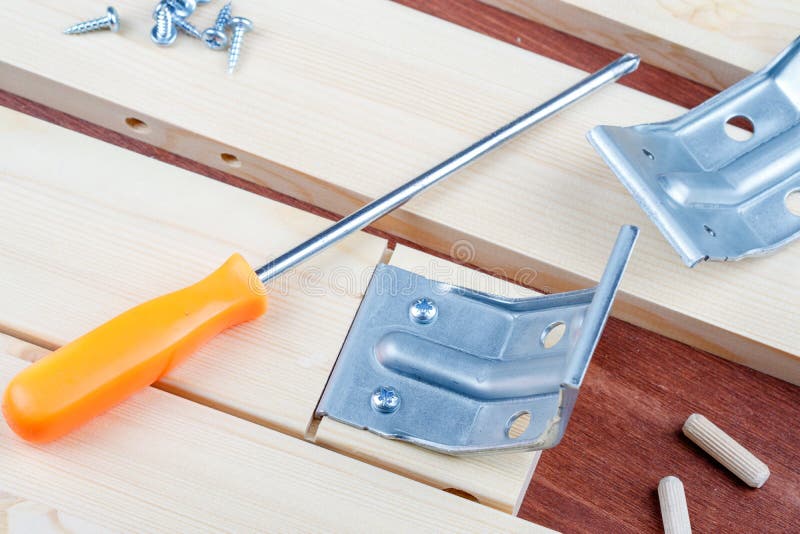 Screwdriver and self-tapping screws with metal corner elements for assembling the table stock image Screwdriver and self-tapping screws with metal corner elements for assembling the table stock image