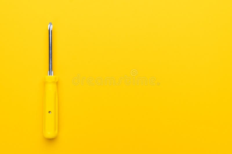 Screwdriver on yellow background