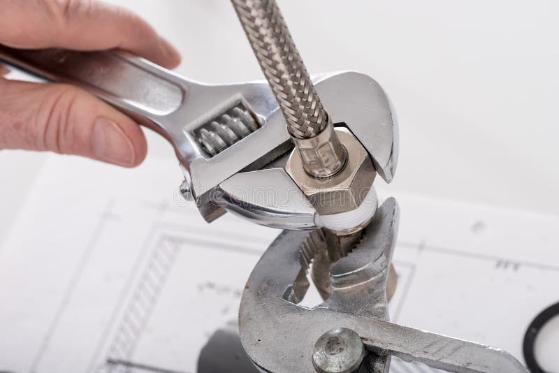 Screwing plumbing fittings stock image