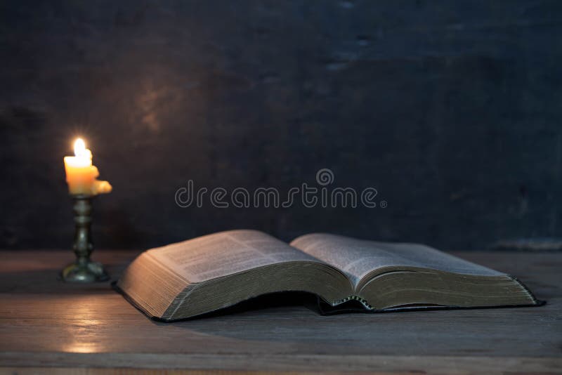 Scriptures and candles on a wooden table